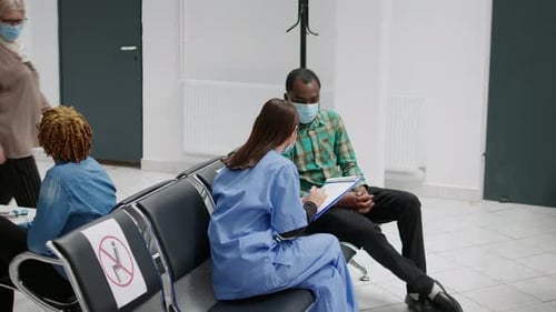Medical Worker Consults with Patient in Hospital Waiting Room
