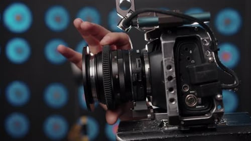 Closeup of the Videographer's Hand Adjusting the Focus on Camcorder