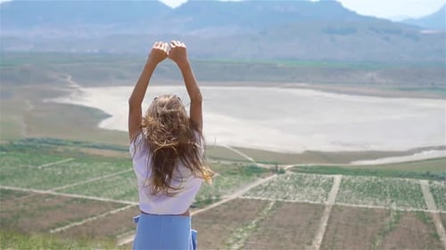 Little Girl Hands Up Near the Lake at the Day Time