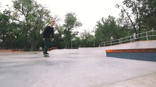 Skateboarder in Skate Park Doing Tricks Slow Motion