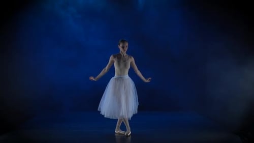 Elegant Ballerina Dancing Ballet in Dark Studio