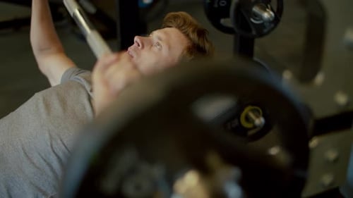 Focused Fit Man Doing Bench Press at Gym. Bodybuilding Man Doing Workout
