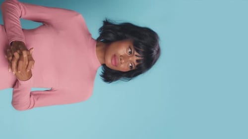 Woman Posing in Pink on Blue Background