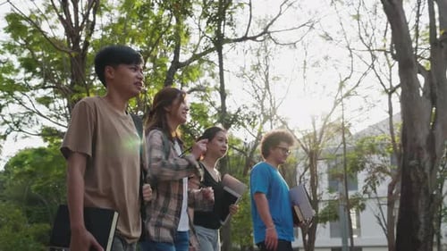 Dolly shot of an attractive multiracial group of college students walking inside college
