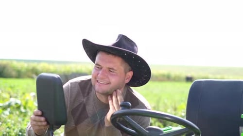 Happy Farmer Near His Green Tractor