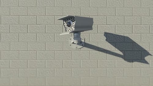 CCTV Security Camera Pans and Scans on Brick Wall