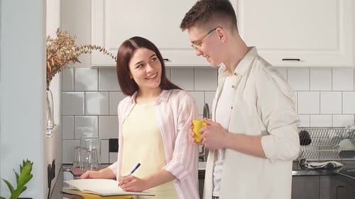 Young Couple Planning Together in Bright Kitchen