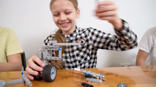 Girl Having Fun Using Building Kit