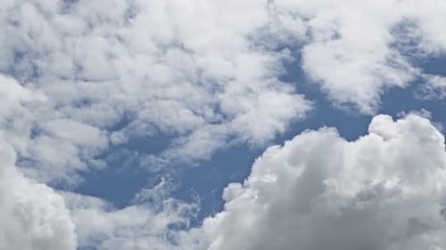 Clouds Drifting Slowly Across a Blue Sky