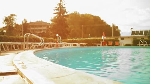 Young Man in Summer Day is Diving Into Outdoor Swimming Pool Dolly