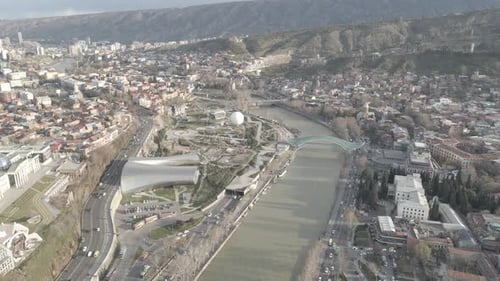 Aerial view of Tbilisi city central park and Bridge of Peace. Beautiful cityscape of old Tbilisi
