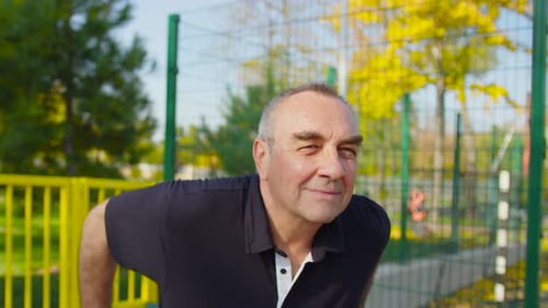 Elderly Man Exercising in and Outdoor Gym