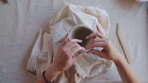 Craftsperson Shaping Clay into Pot