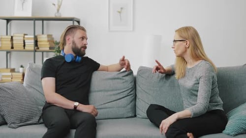 Man and Woman Having Difficult Conversation on Couch