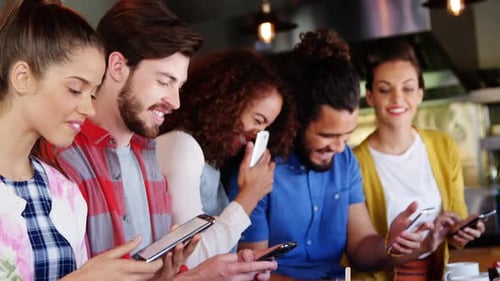 Friends using smartphones at urban cafe table