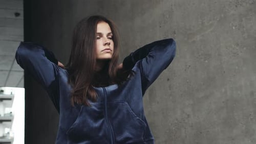 Girl Puts on Hooded Jacket Outdoors