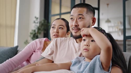 Loving Family Relaxing Together on Sofa