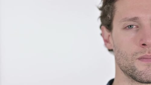 Close Up of Half Face of Serious Young Man on White Background
