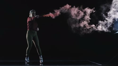 Woman Holding Smoking Flare in Black Studio