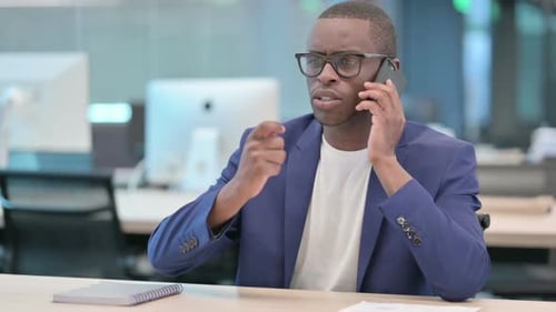 Young Adult in Office Talking on Phone