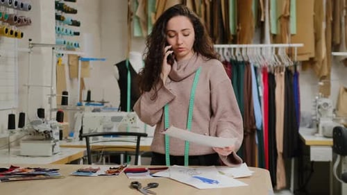 Fashion Designer Talking on Phone in Studio