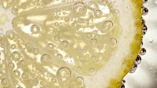 Lemon Slice in Sparkling Water with Bubbles