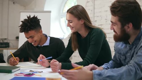 Happy Diverse Group of Students or Young Business Team Working on a Project