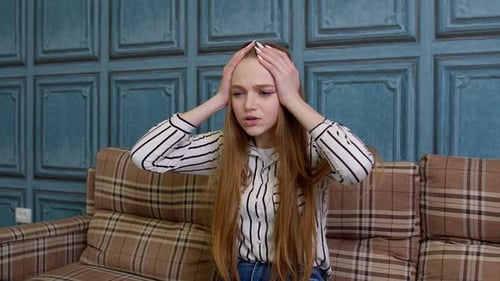 Sad Upset Dissatisfied Irritated Girl Reading Bad News on Laptop Computer Grabs Head in Despair