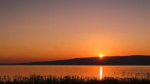 Golden Sunset Time-Lapse Over a Tranquil Lake