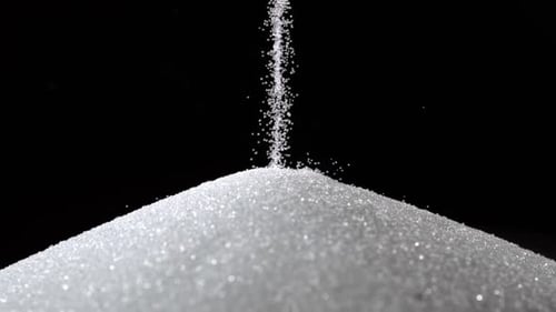 Pile of sugar on black background, Slow Motion