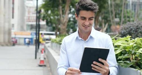 Man Uses Tablet in Urban Setting