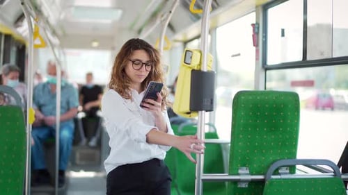 Woman paying public city transport with mobile phone app. Female modern passinge