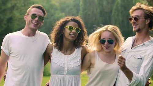 Multiethnic Friends Hugging and Dancing at Party Outdoors, Happiness on Faces