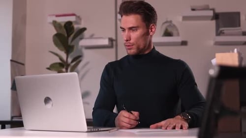 Businessman Working with Laptop and Writing Sitting at Table in Modern Corporate Office Spbi