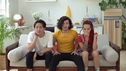 Friends Reacting to Exciting Game at Home