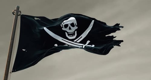 Tattered Pirate Flag Waving on Mast Against Cloudy Sky