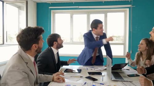 Team Celebrates Success in Office With High Fives