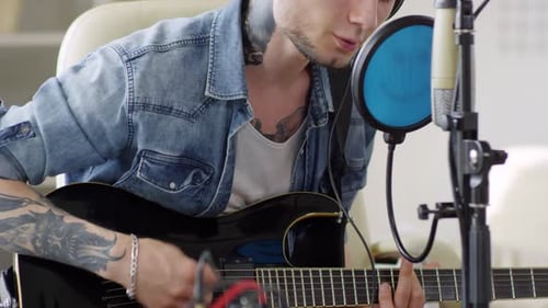 Musician Playing Guitar and Singing at Home