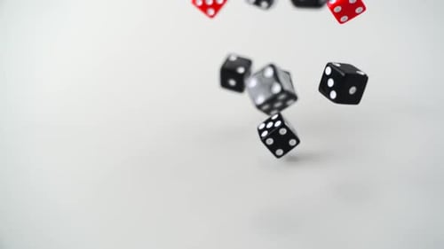 Red and Black Dice Falling in Slow Motion