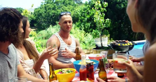 Friends Gathering Outdoors in Summer Enjoying Food and Drinks