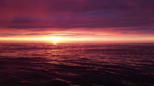 Beautiful aerial vibrant high contrast pink purple sunset over Baltic sea, Karosta war port concrete