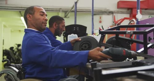 Mechanics assembling the wheels with an object