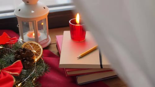 Christmas Books and Candles on Windowsill