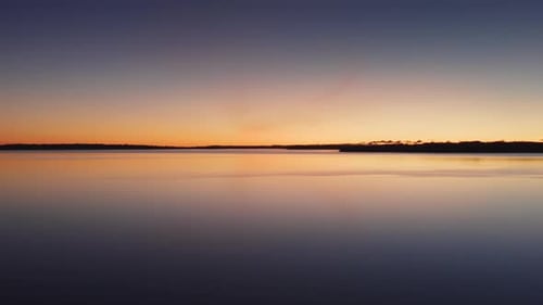 Drone Over Tranquil Waters At Sunset