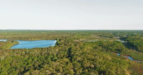 Aerial panorama view on the turquoise color lake between green forest.