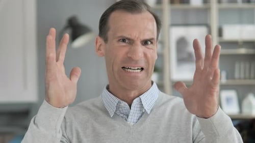 Man Yelling and Gesturing Angrily Indoors