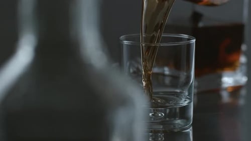 Whisky is poured into glass in slow motion; shot on Phantom Flex 4K at 1000 fps