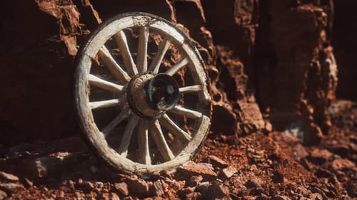 Abandoned Rustic Wooden Wagon Wheel in Rocky Landscape