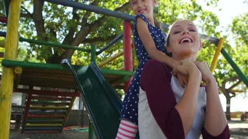 Mother and daughter playing in the playground
