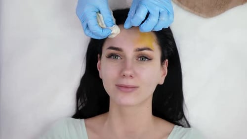 Woman Receives Facial Treatment in Beauty Salon